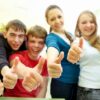 group of cheerful young students hands gesture shows OK in the classroom